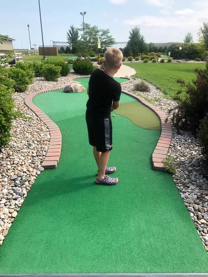 AJ's Arcade - Kid playing Mini-Golf